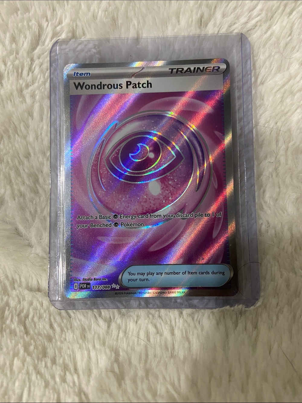 This full-art, Ultra Rare edition of Wondrous Patch (#117/088) POR
